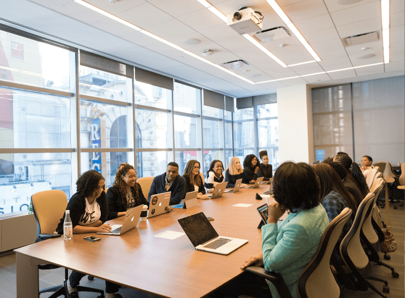Executives in a boardroom receiving board governance consulting and board of directors consulting to strengthen strategic leadership